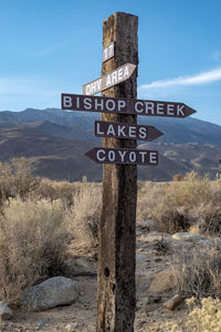 Wooden signpost hand-lettered arrows signs in the eastern sierra nevadas, california, usa