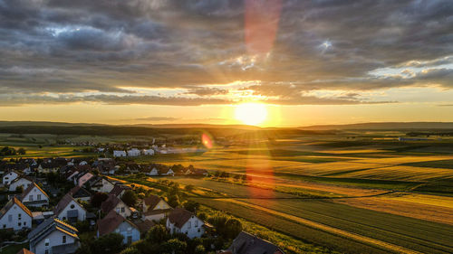 Aerial view of buildings against sky during sunset