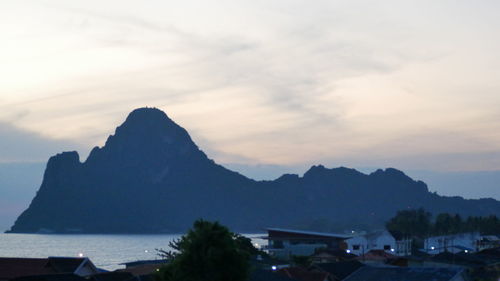 Scenic view of sea and mountains against sky