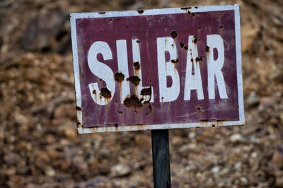 Close-up of information sign on wood