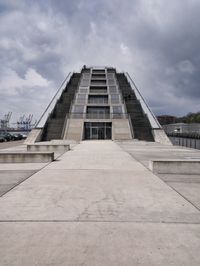 Low angle view of modern building against cloudy sky