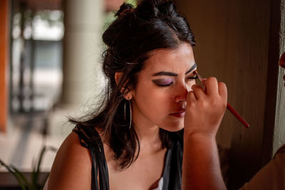 Side view of young woman looking away