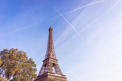 Low angle view of tower against cloudy sky