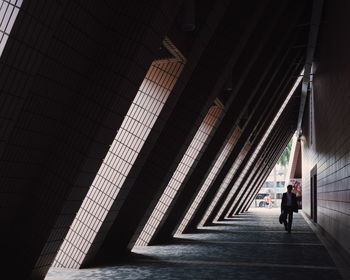 Businessman walking in corridor of building