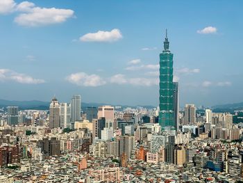 Aerial view of modern buildings in taipei against sky