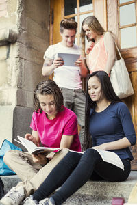 Students studying at the entrance of university