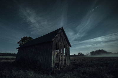 Dilapidated building by night.