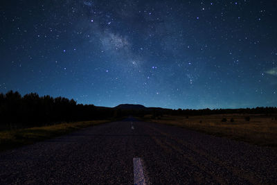 Road against sky at night