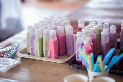 Close-up of multi colored bottles on table