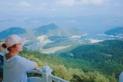 Woman looking down from lookout tower