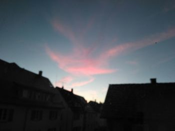 Low angle view of silhouette buildings against sky at sunset