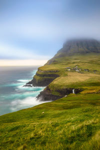 Scenic view of sea and mountains against sky