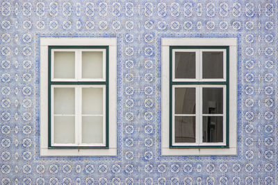 Windows on pattern tile wall of house