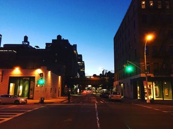 Illuminated road in city at night