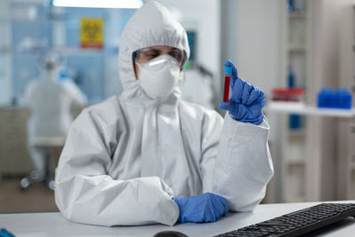 Female scientist holding blood sample in laboratory