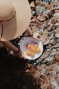 High angle view of woman holding fresh fruits 