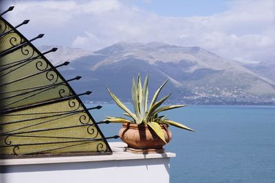 Scenic view of sea and mountains against sky