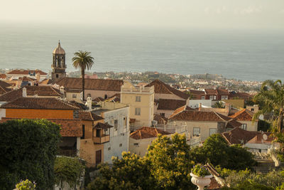 High angle view of townscape by sea