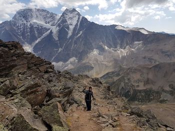 Man surfing on rock in mountains against sky