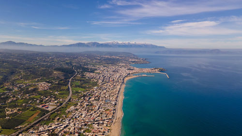 High angle view of sea and cityscape against sky