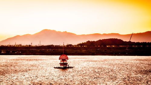 Scenic view of lake against sky during sunset