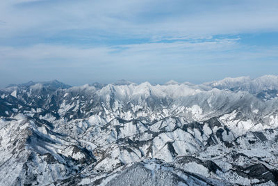 Scenic view of snowcapped mountains against sky