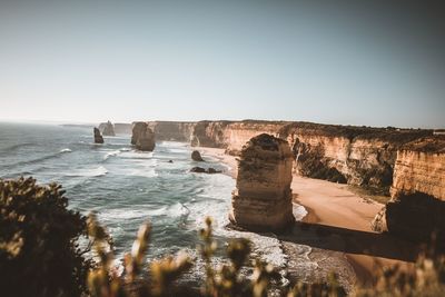 Twelve apostles in sea against sky