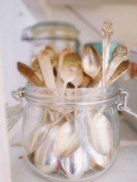 Stack of spoons in glass jar on table