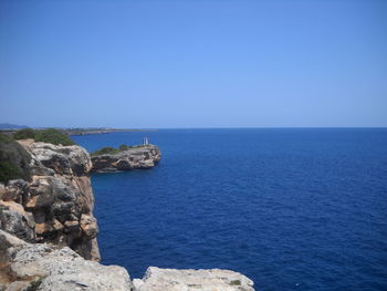 Scenic view of sea against clear blue sky