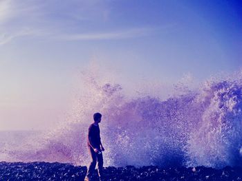 Rear view of man standing on beach