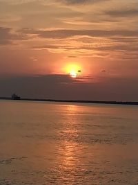 Scenic view of sea against romantic sky at sunset