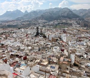 High angle view of townscape against mountains