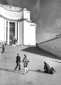 People on sidewalk in city