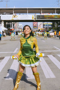 Portrait of a young woman standing on street