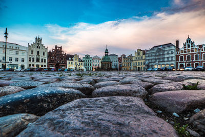 View of cityscape against cloudy sky