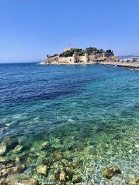 Scenic view of sea against clear blue sky