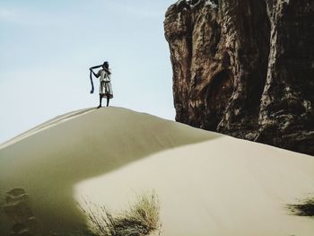 Rear view of man standing on rock