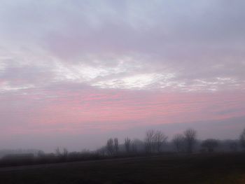 Scenic view of landscape against sky at sunset