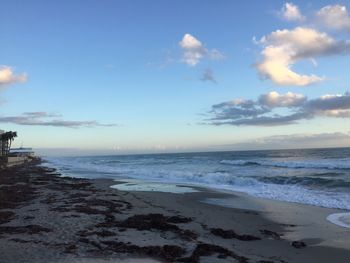 Scenic view of beach against sky during sunset