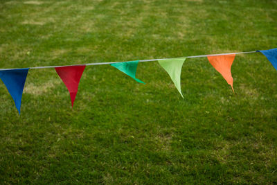 Multi colored flags hanging on field