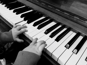 Close-up of hands playing piano