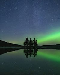 Scenic view of lake against sky at night