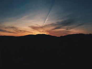 Silhouette mountains against sky at sunset