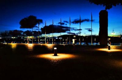 View of illuminated street lights at night