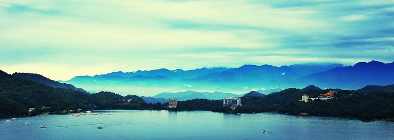 Scenic view of lake against cloudy sky