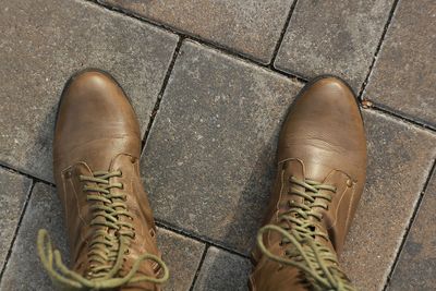 Low section of man standing on footpath