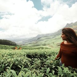 Smiling woman standing on tea farm
