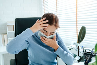 Young woman using mobile phone at home