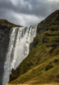 Low angle view of waterfall against sky