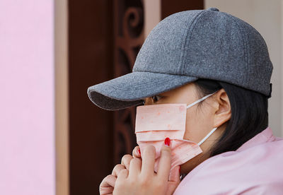 Close-up portrait of woman holding eyeglasses